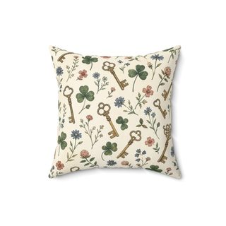 Square throw pillow printed with a pattern of antique keys, clover and small flowers